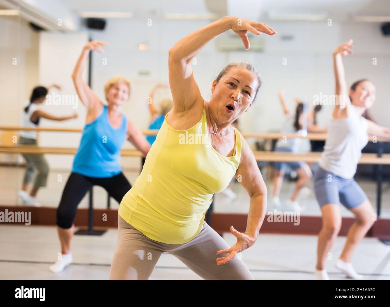 Old lady dancing in studio with women Stock Photo
