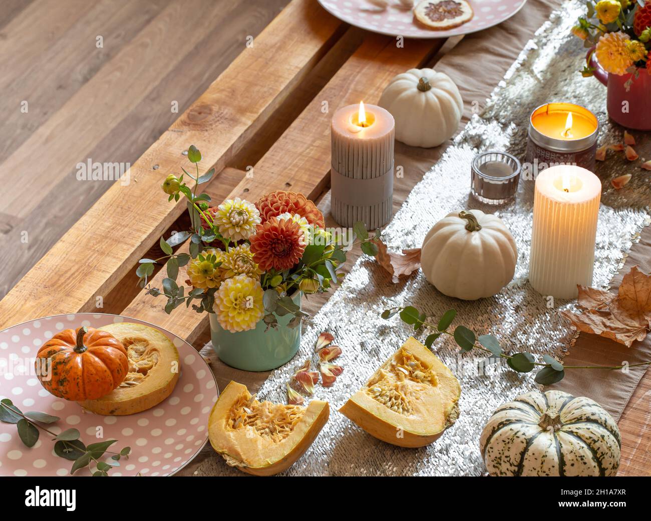 Festive table setting with pumpkins and chrysanthemum flowers. Stock Photo