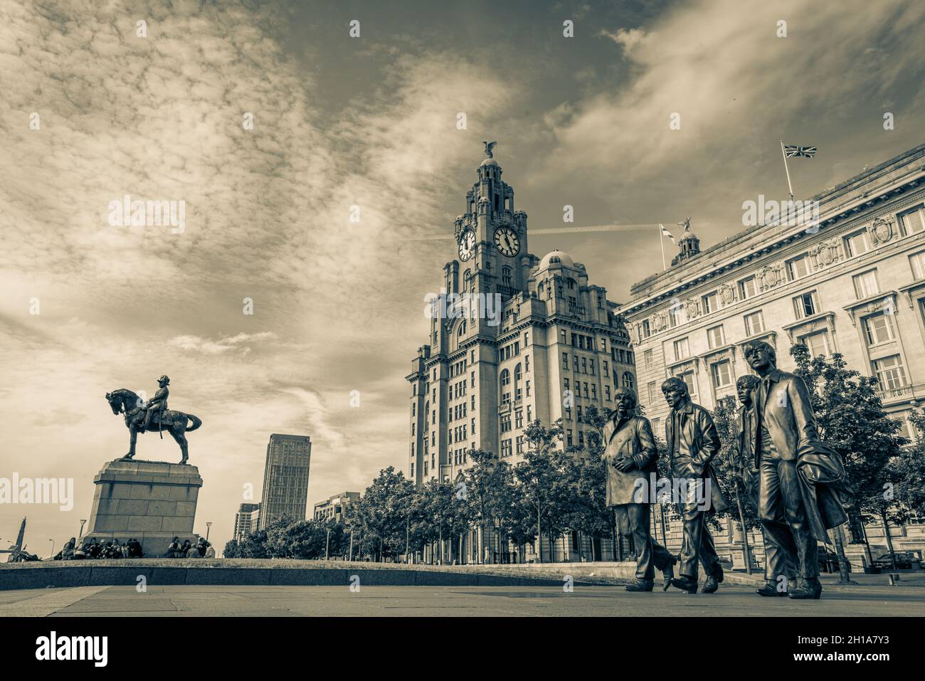 The Beetles at Liverpool waterfront in front of the Three Graces - the Royal Liver Building, The Cunard Building and the Port of Liverpool Building. Stock Photo