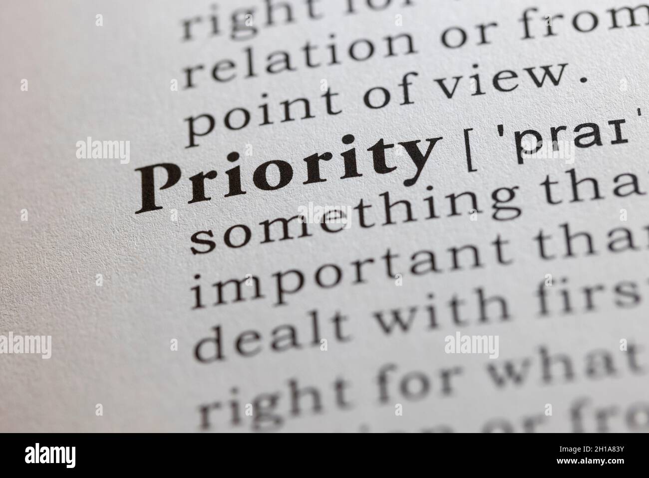 Fake Dictionary word, Dictionary definition of priority, first priority, Stock Photo