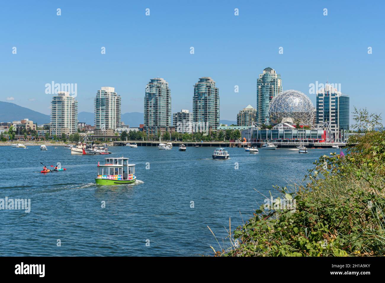 An Aquabus sails towards Science World and downtown apartment towers in