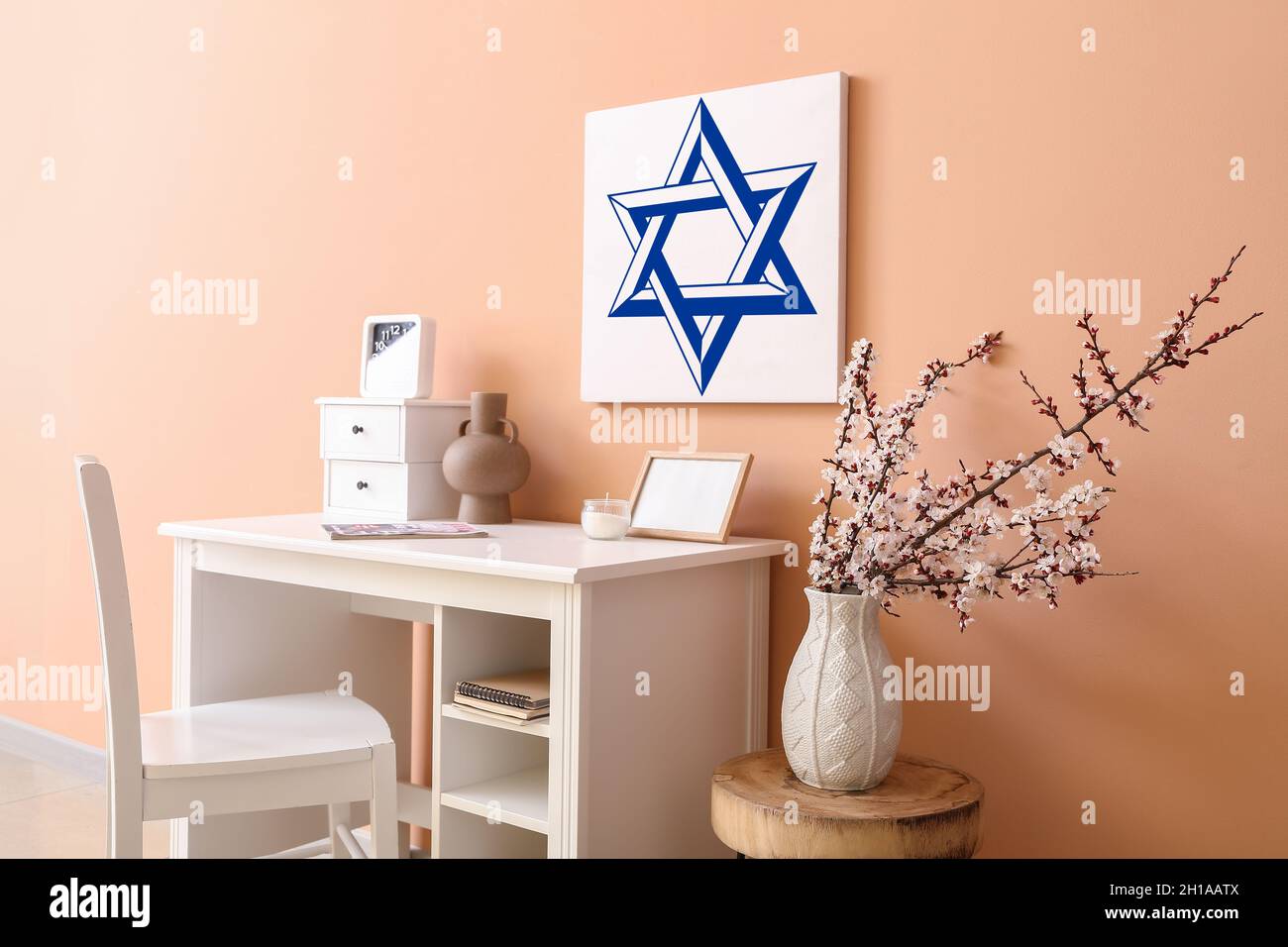 Painting of David Star hanging on color wall in interior of room Stock Photo