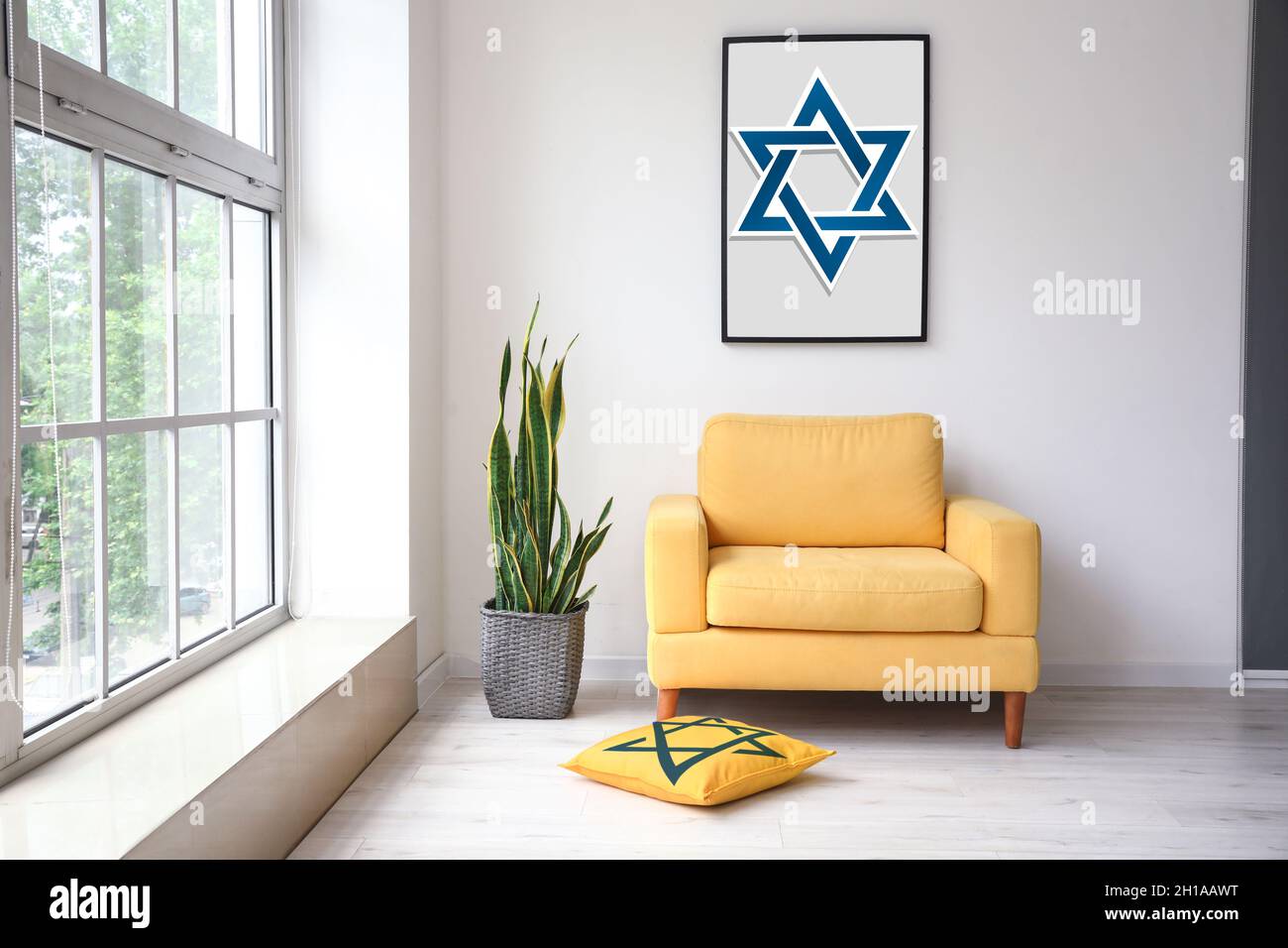 Painting of David Star hanging on light wall in interior of room Stock Photo