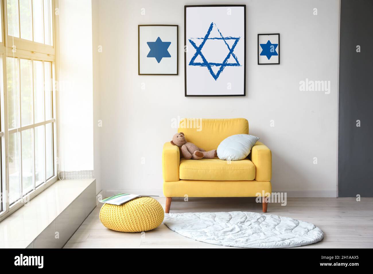 Paintings of David Stars hanging on light wall in interior of room Stock Photo