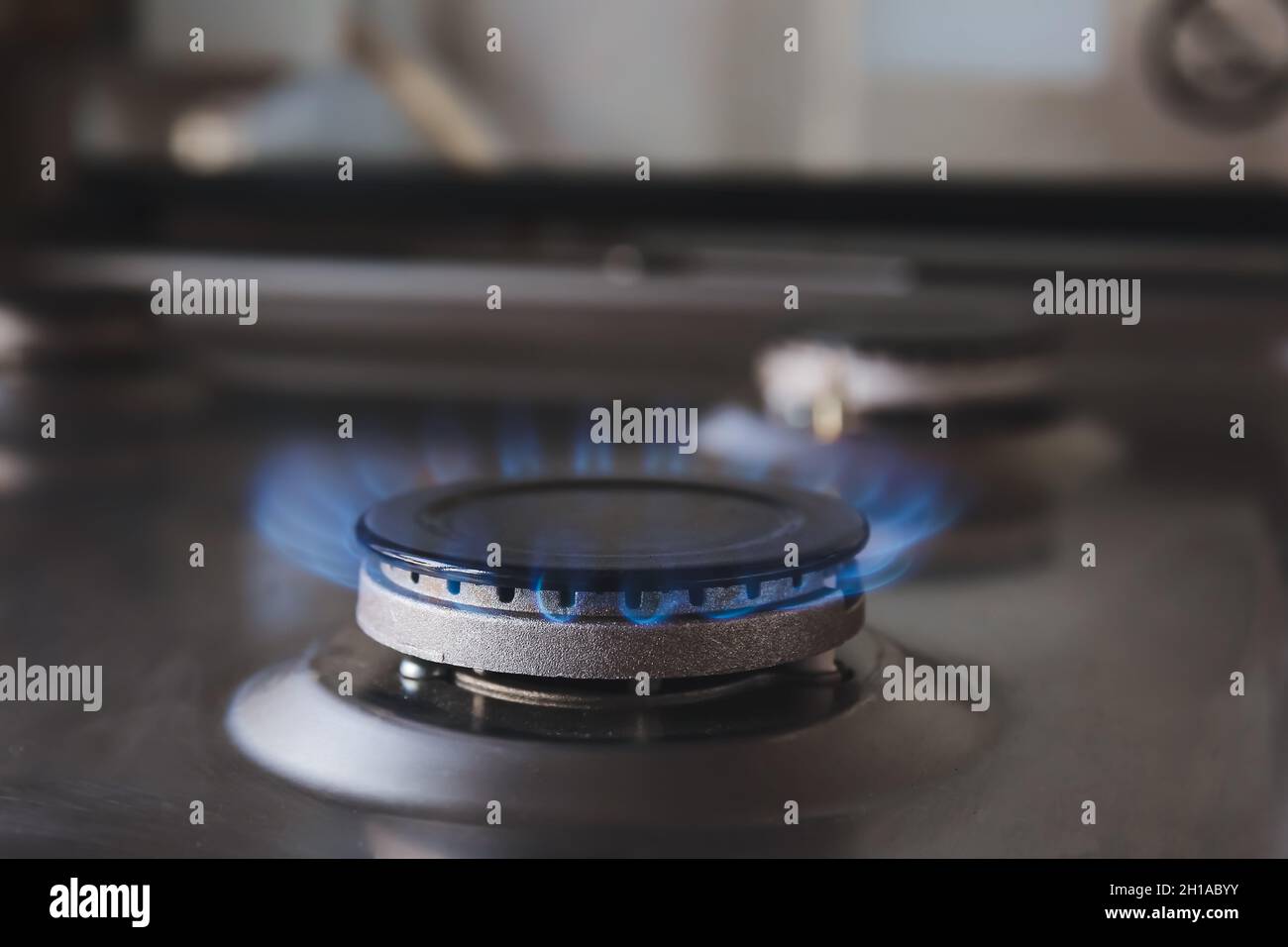 Gas burner with blue flame on domestic stove, closeup Stock Photo Alamy