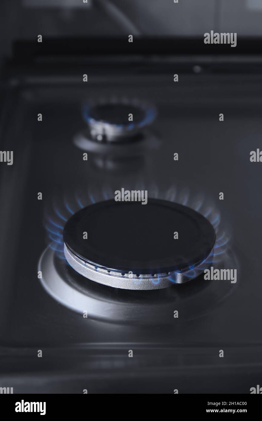Gas burner with blue flame on domestic stove, closeup Stock Photo Alamy