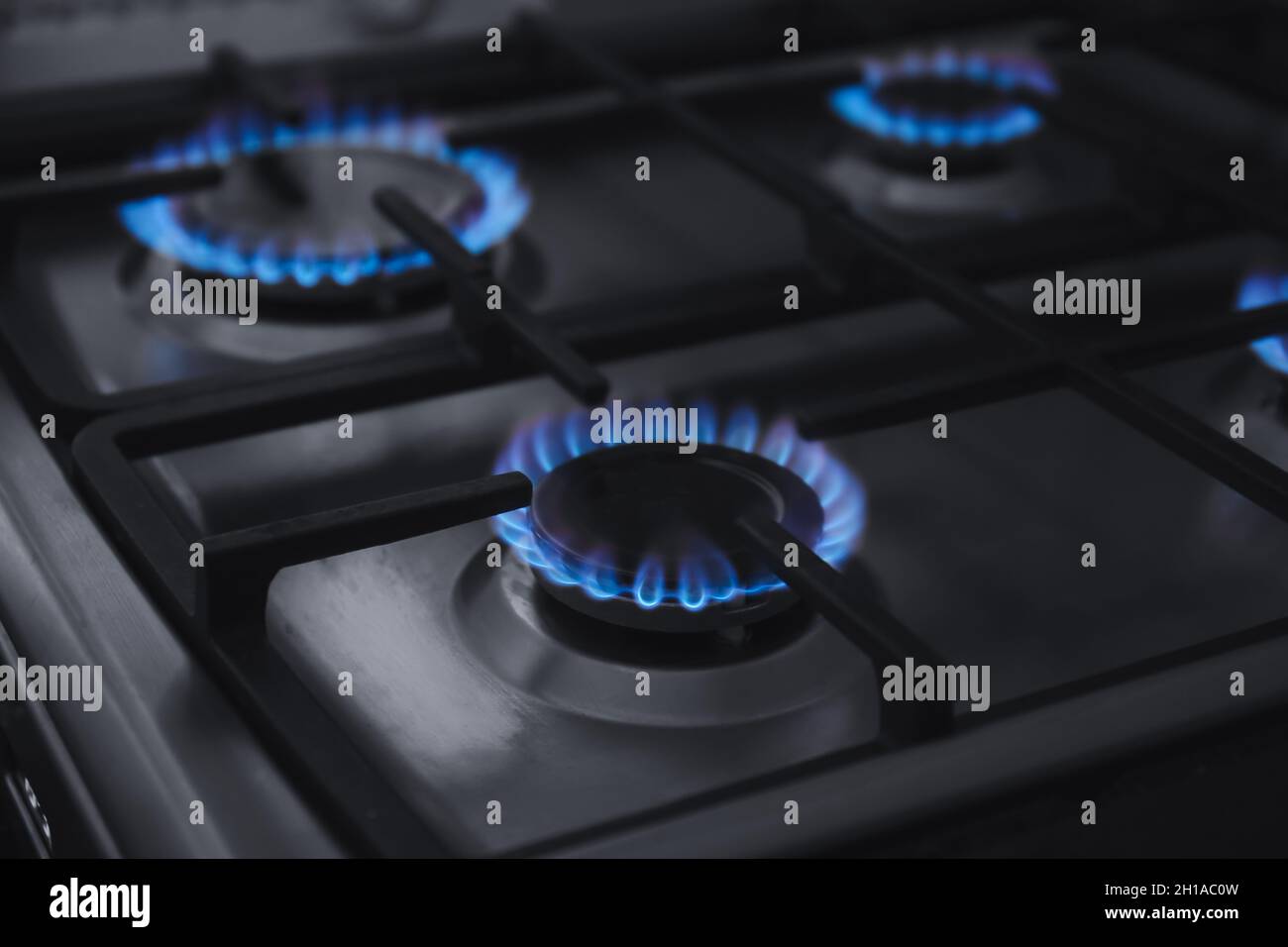 Gas burner with blue flame on domestic stove Stock Photo Alamy