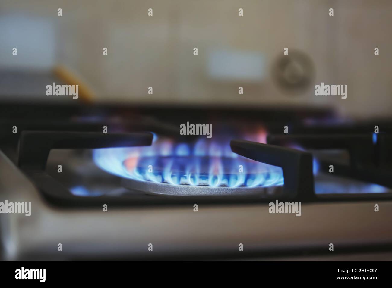 Gas burner with blue flame on domestic stove, closeup Stock Photo Alamy