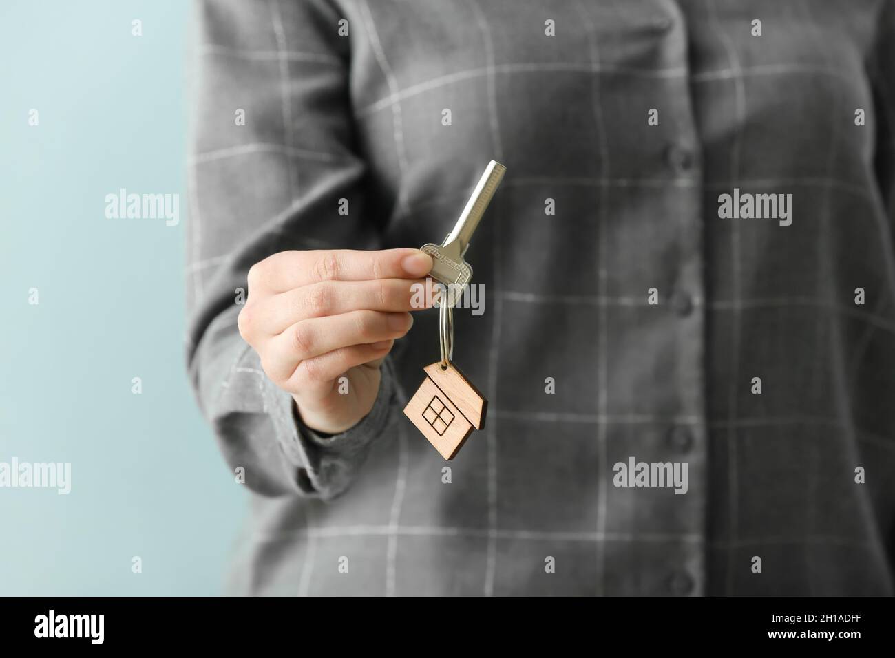 Real estate agent holding key from house with keychain, closeup Stock ...
