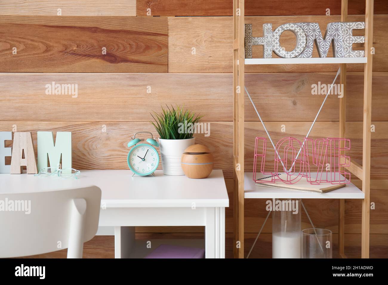 Interior of stylish living room with alarm clock on modern workplace ...