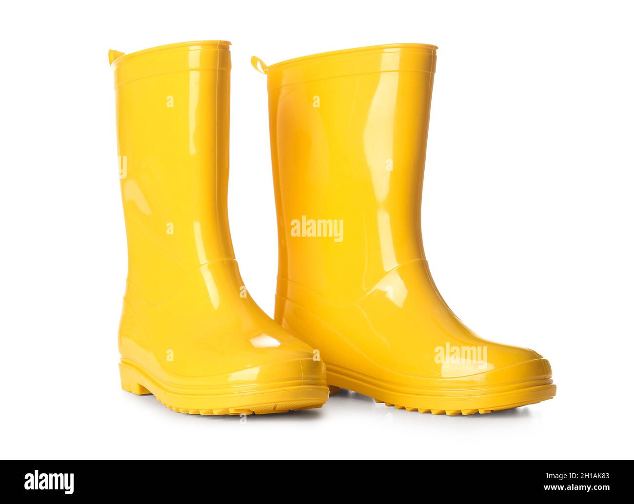 Pair of yellow rubber boots on white background Stock Photo - Alamy