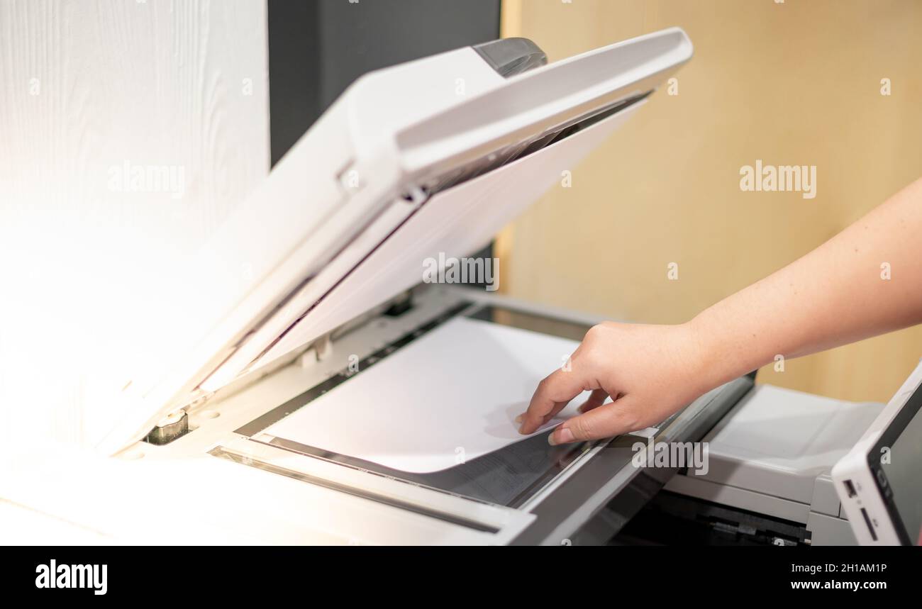 Business woman hand lay down or take papers from laser copy machine for  process paperwork on laser print cartridge at the office Stock Photo - Alamy