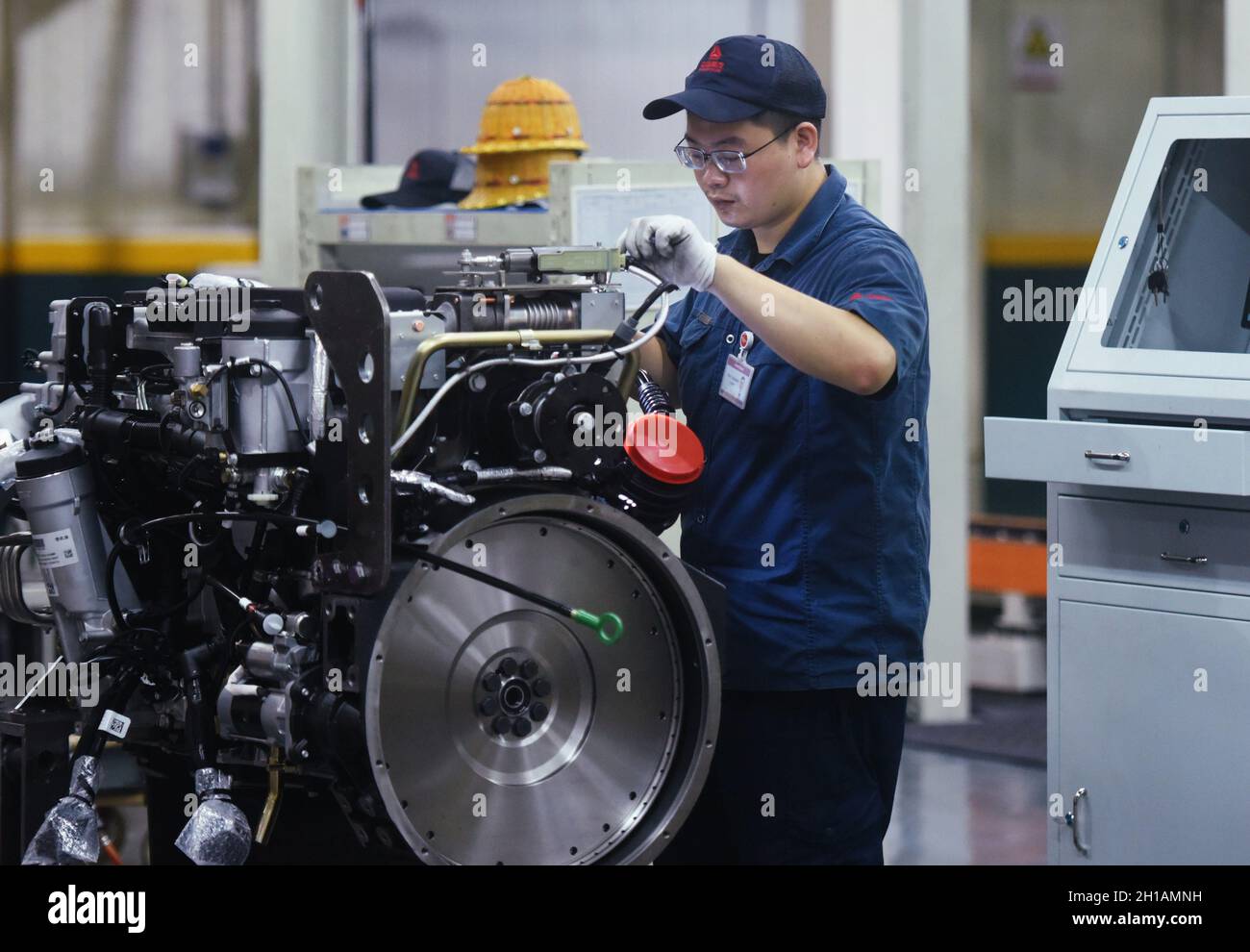 HANGZHOU, CHINA - OCTOBER 18, 2021 - A worker assembles heavy truck ...
