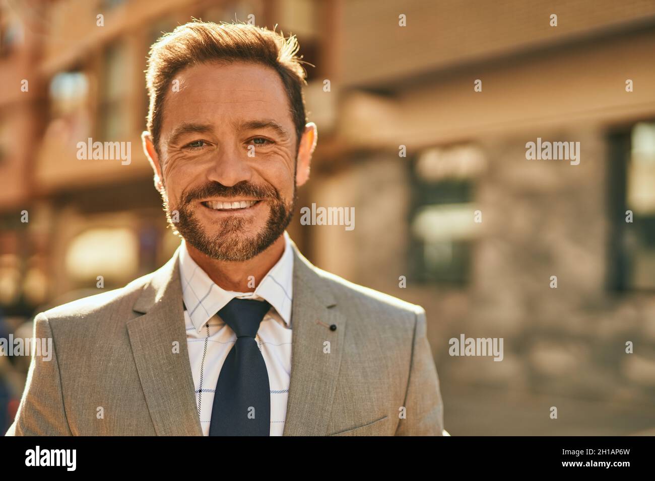 Middle age businessman smiling happy standing at the city Stock Photo ...