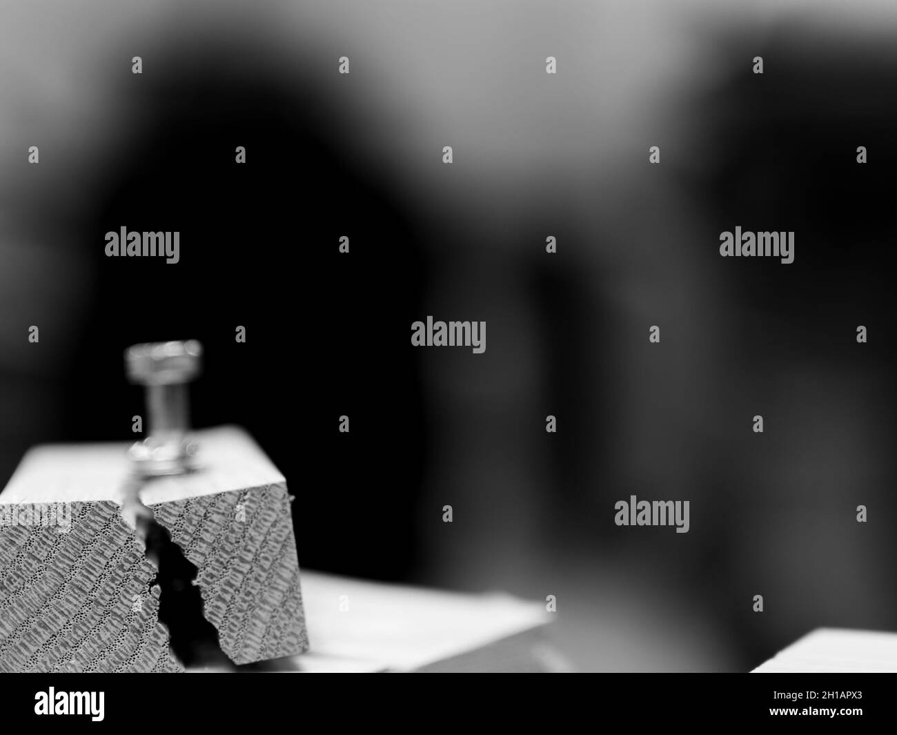 Selective focus on cracked and split wood from not drilling a pilot