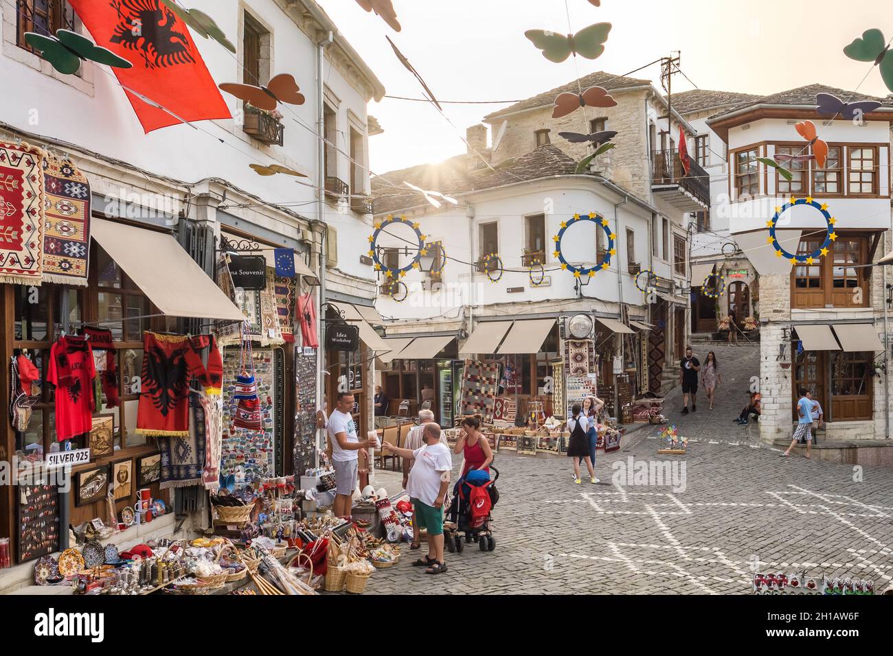 Street scene with souvenir shops in old town of Gjirokaster in Albania. Stock Photo