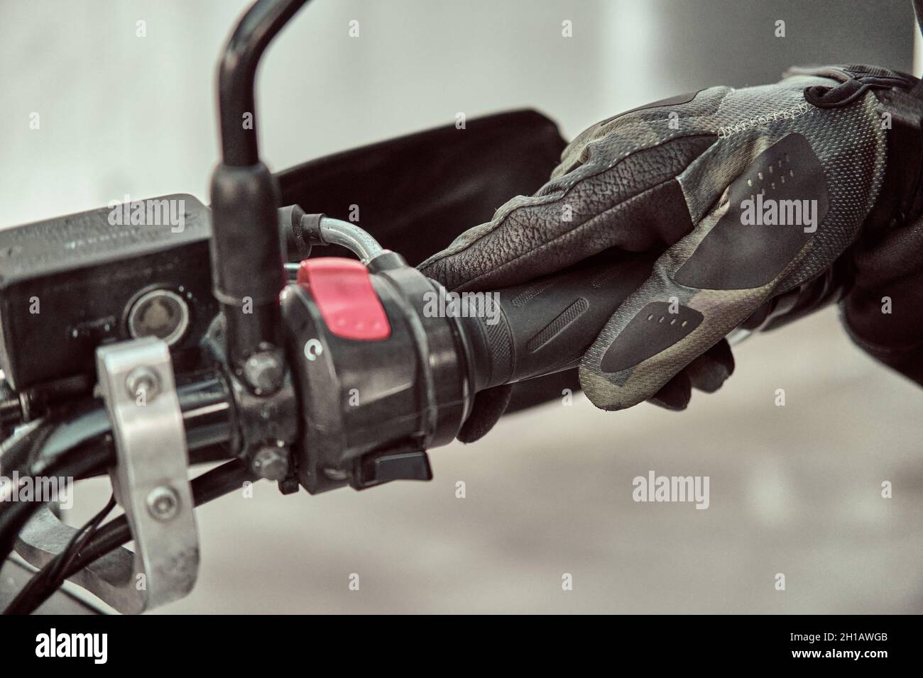 Biker holds onto throttle handle of a motorcycle. Close up shot Stock Photo