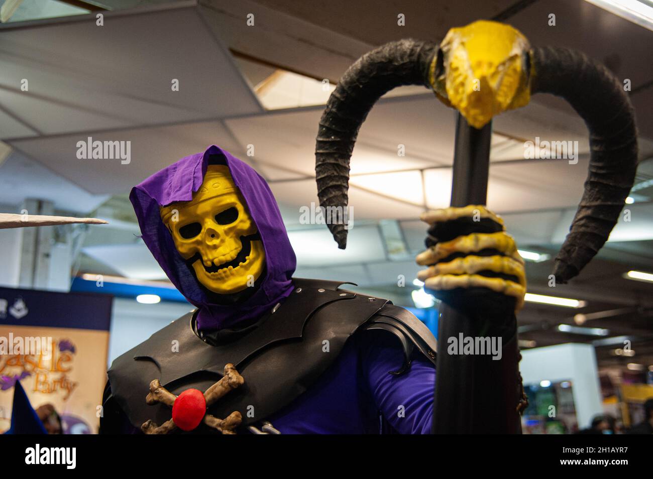 A fan of Hee-Man poses for a photo using a costume of Skeletor during the fourth day of the SOFA (Salon del Ocio y la Fantasia) 2021, a fair aimed to the geek audience in Colombia that mixes Cosplay, gaming, superhero and movie fans from across Colombia, in Bogota, Colombia on October 17, 2021. Stock Photo