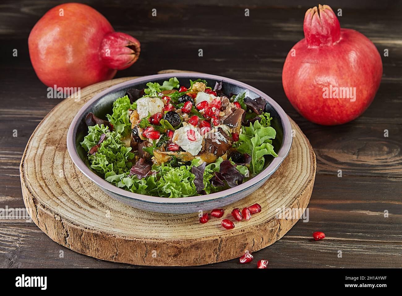 Eggplant salad with feta cheese, pomegranate and currants in a coffee marinade. French gourmet cuisine Stock Photo