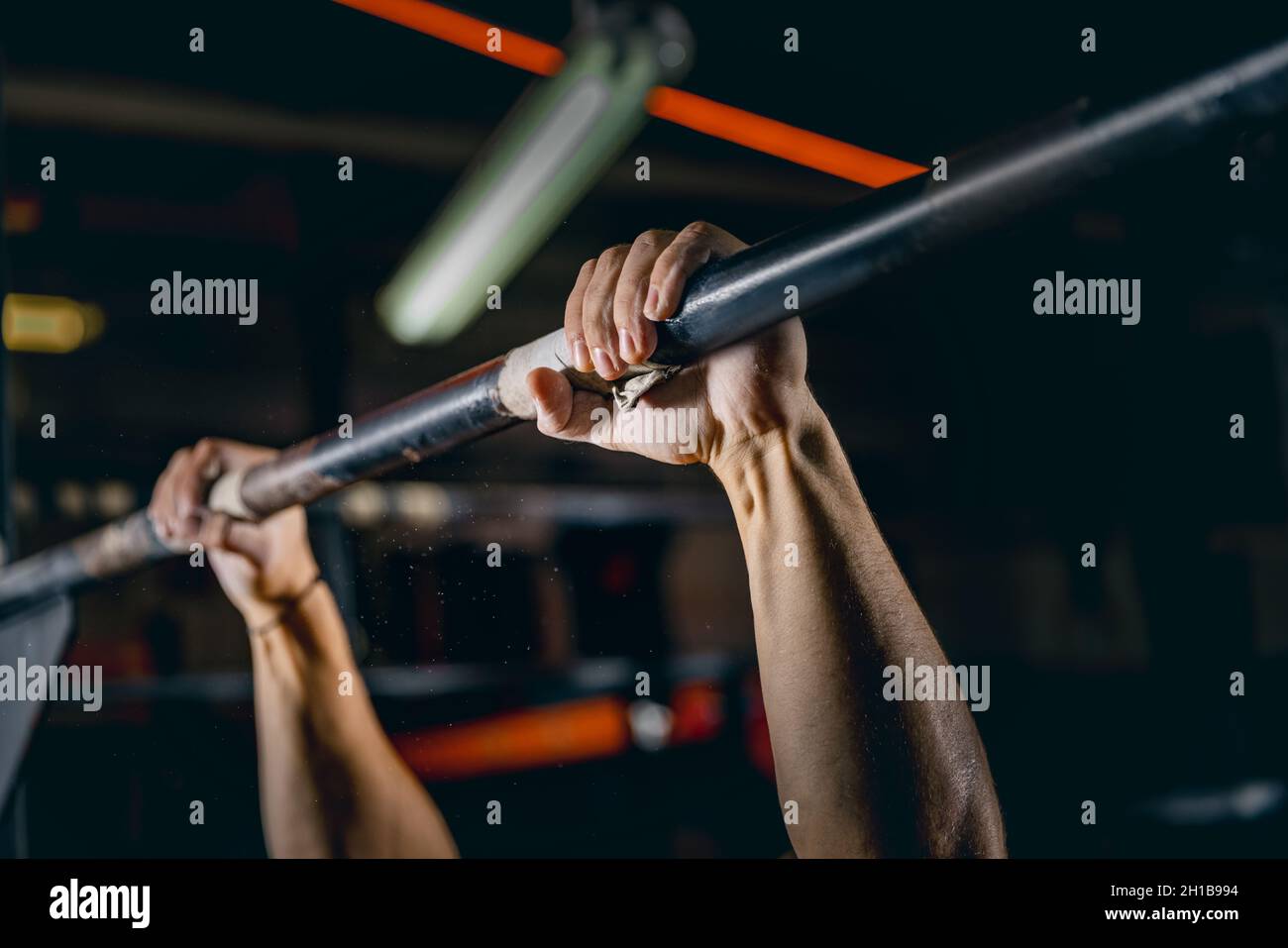 Closeup image of strong male hands doing pullups exercise. Man