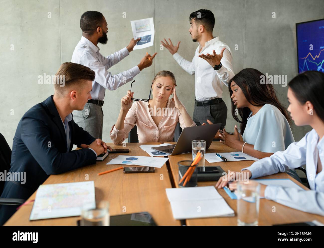 Workplace Conflicts. Stressed Group Of Business People Having Disagreements During Corporate Meeting Stock Photo