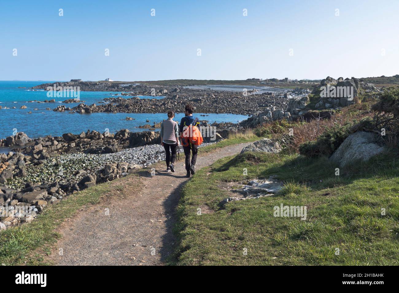 dh Footpath VALE GUERNSEY Couple walking north coast path people Stock Photo