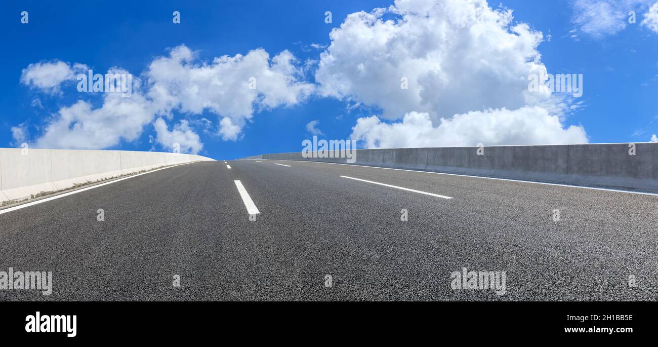 Asphalt highway ground and blue sky with white clouds scene Stock Photo ...