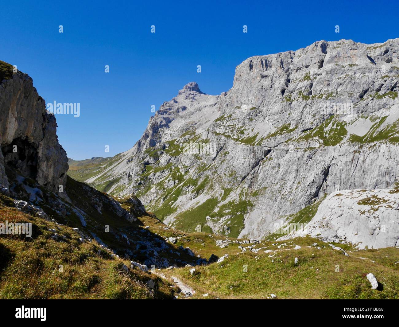 Hiking path through rocky landscape surrounded by Sulzfluh and Scheienfluh in Praettigau, Graubuenden, Switzerland. Stock Photo