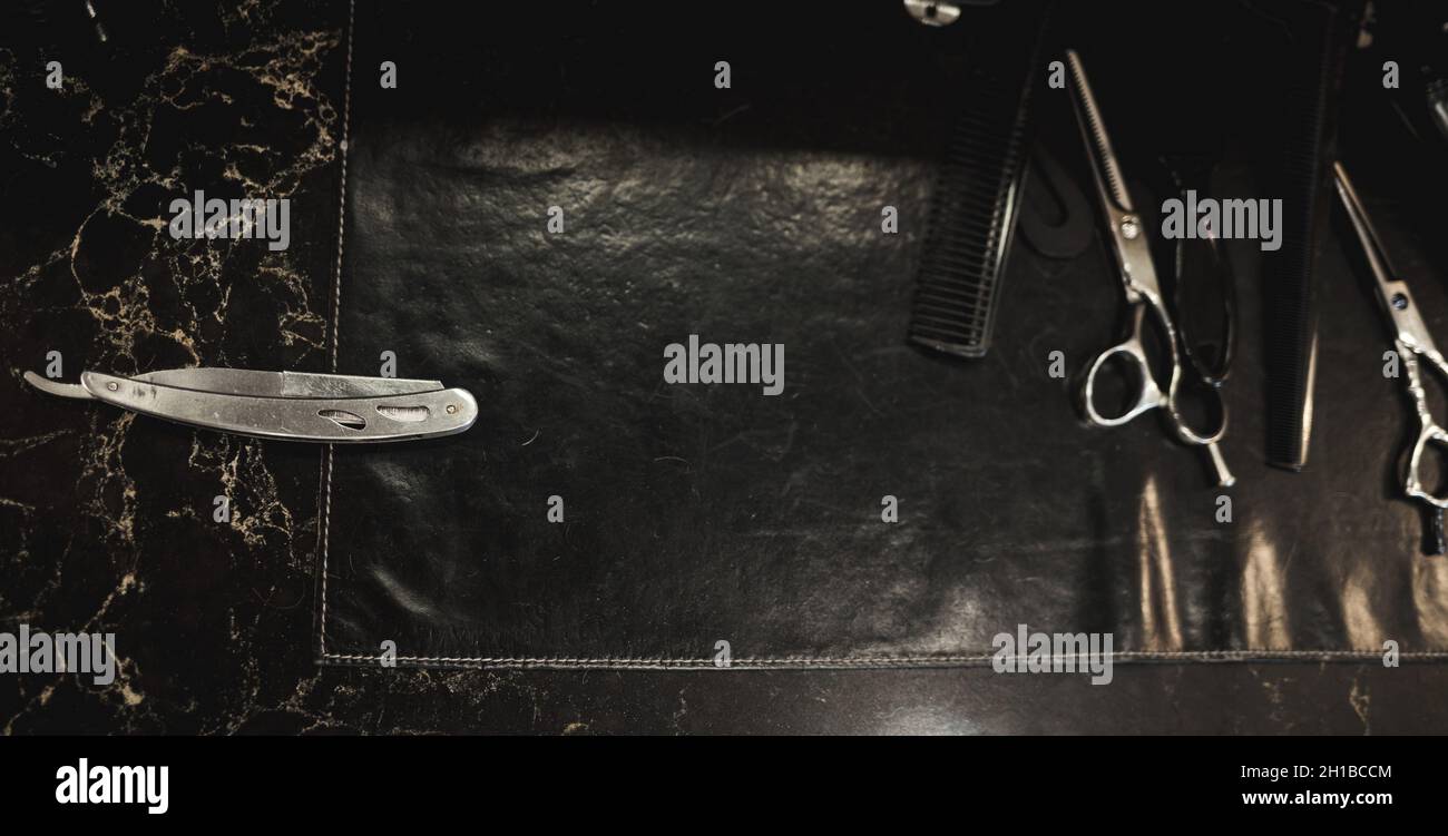 Barber shop tools on desk. dangerous razor Stock Photo - Alamy
