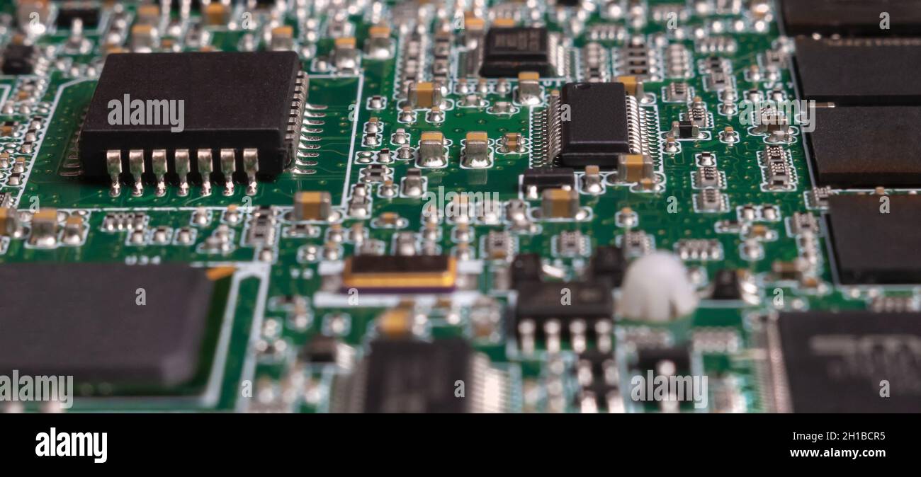 printed circuit board with surface mounted passive and active circuit components close up Stock Photo
