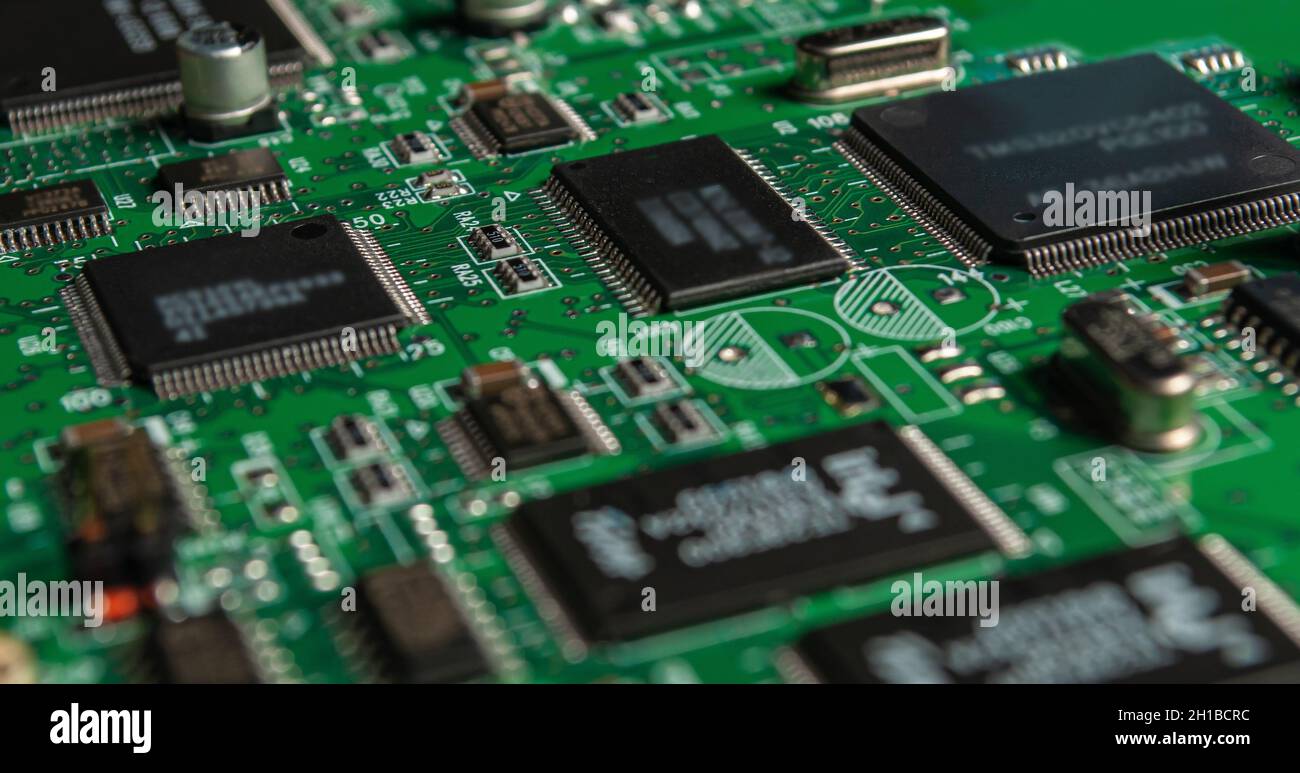 printed circuit board with surface mounted passive and active circuit components close up Stock Photo