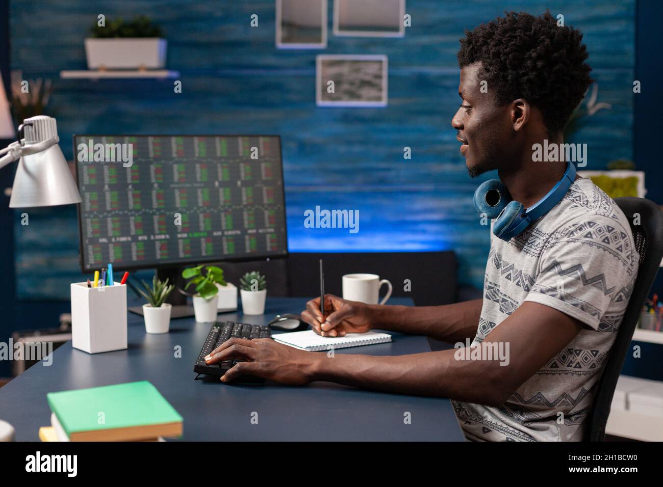 African american business man analyzing stock market chart on computer  developing investment strategy. Young broker trading crypto currency  working remote from home. Investment data on screen Stock Photo - Alamy