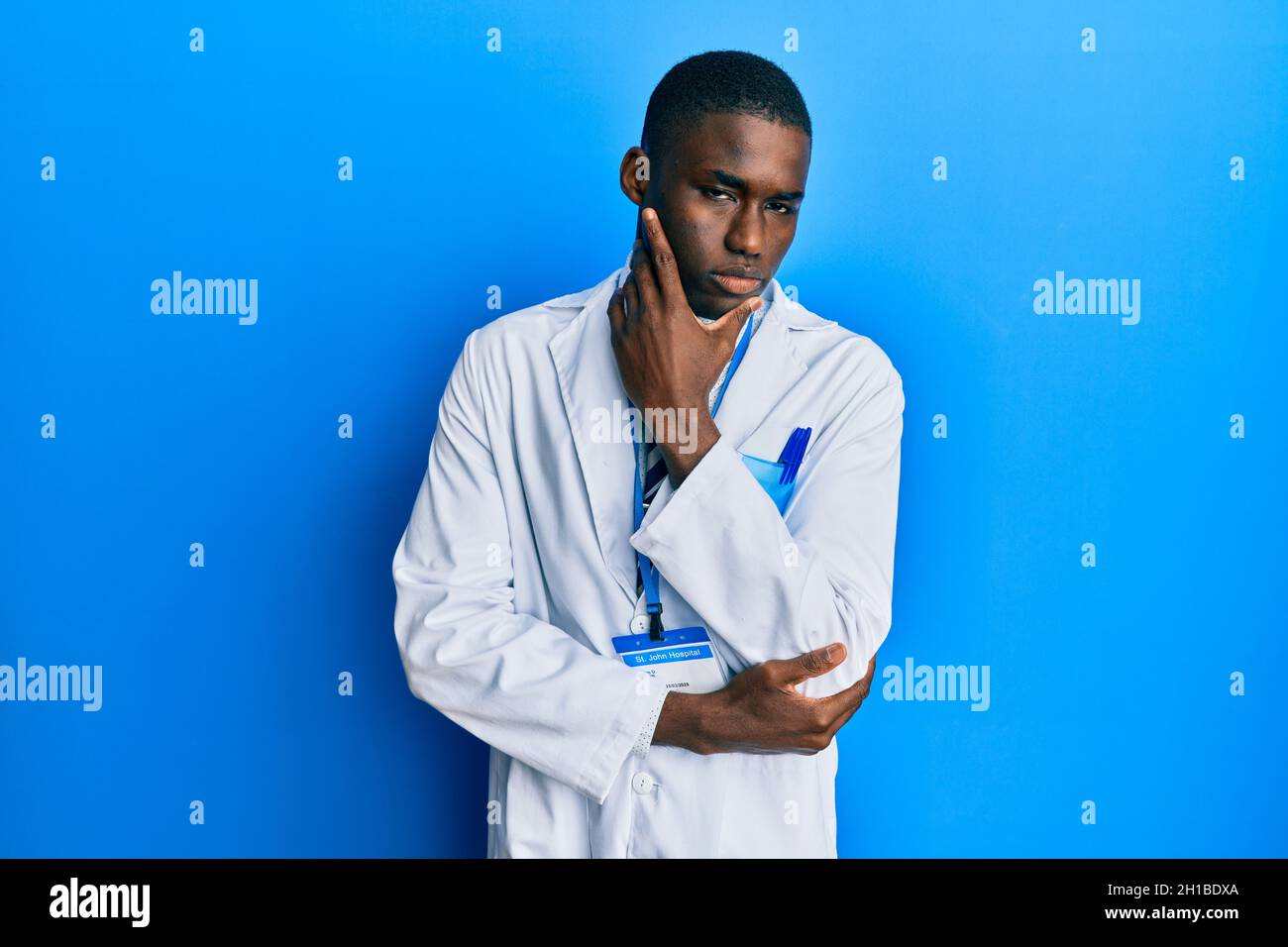 Young african american man wearing scientist uniform thinking looking
