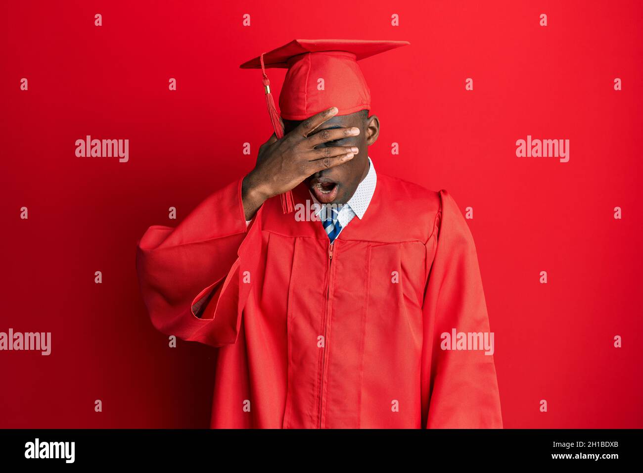 Young african american man wearing graduation cap and ceremony robe ...