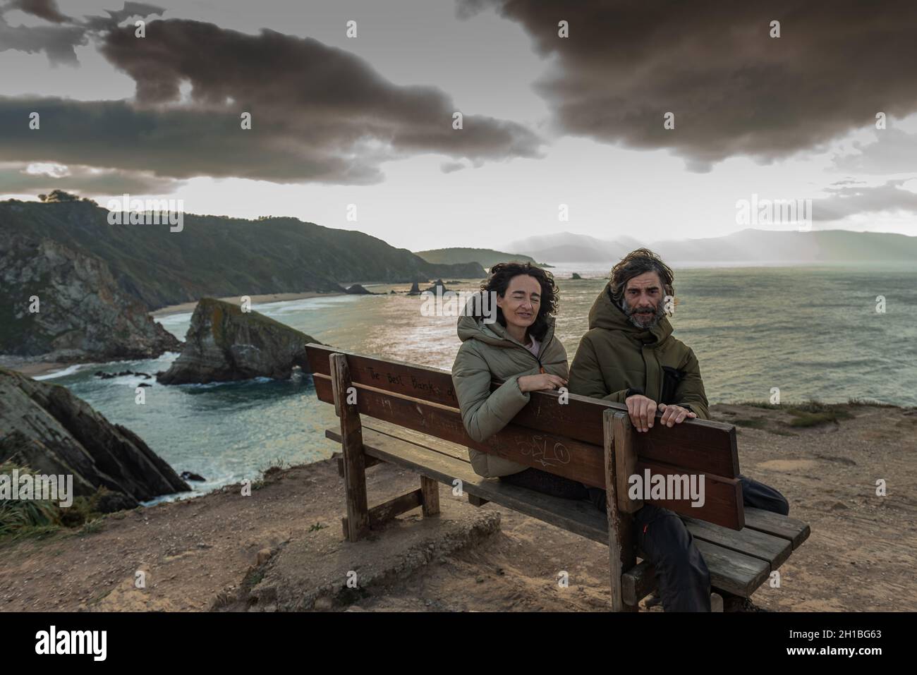 young married couple sitting on the best bench in the world Stock Photo