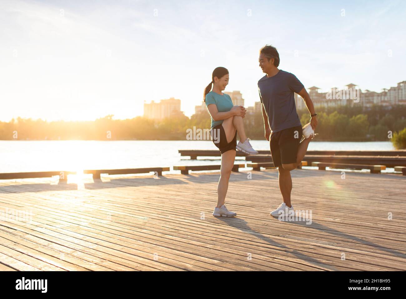Happy mature couple exercising in park Stock Photo - Alamy