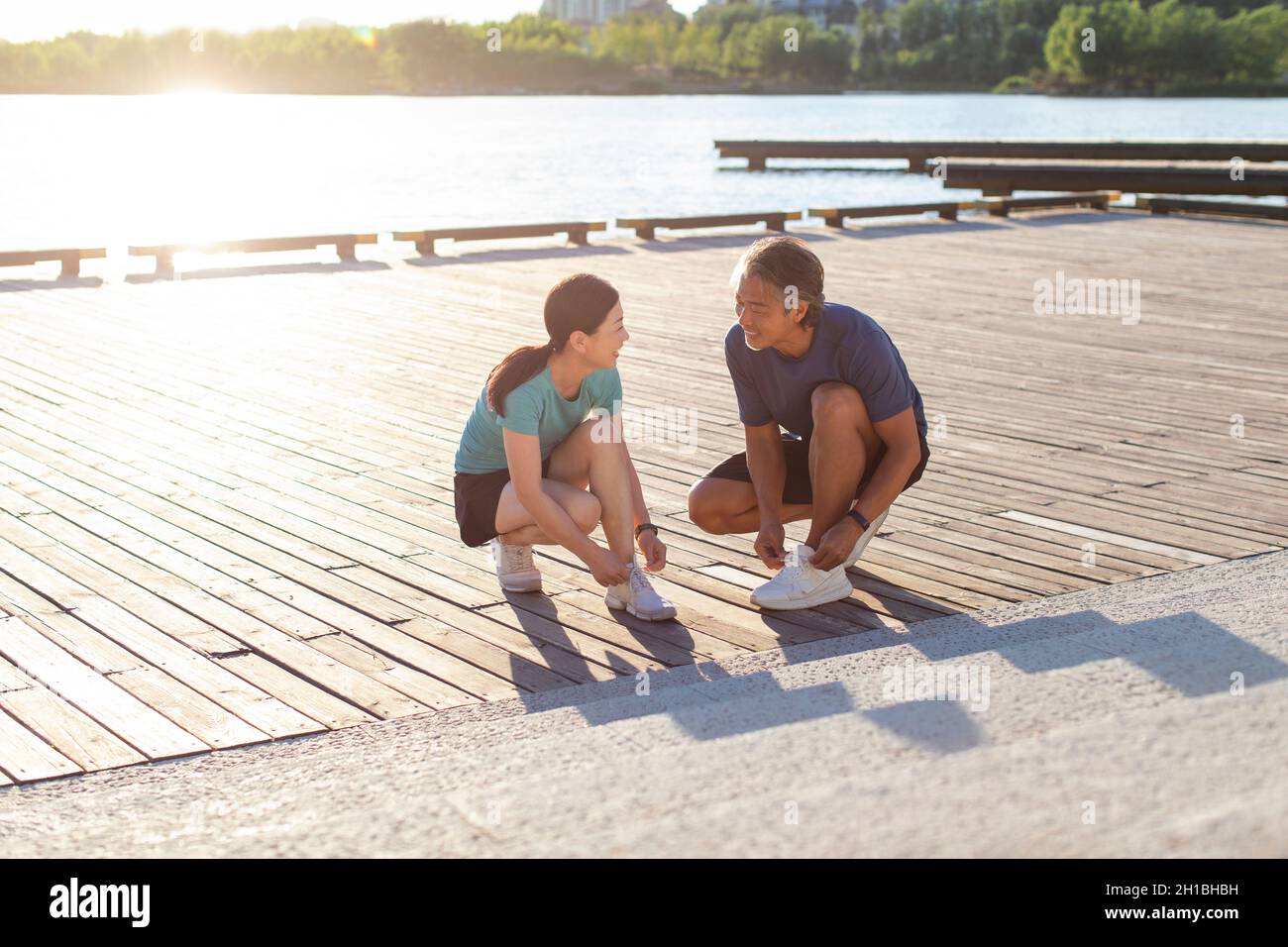Happy mature couple exercising in park Stock Photo - Alamy
