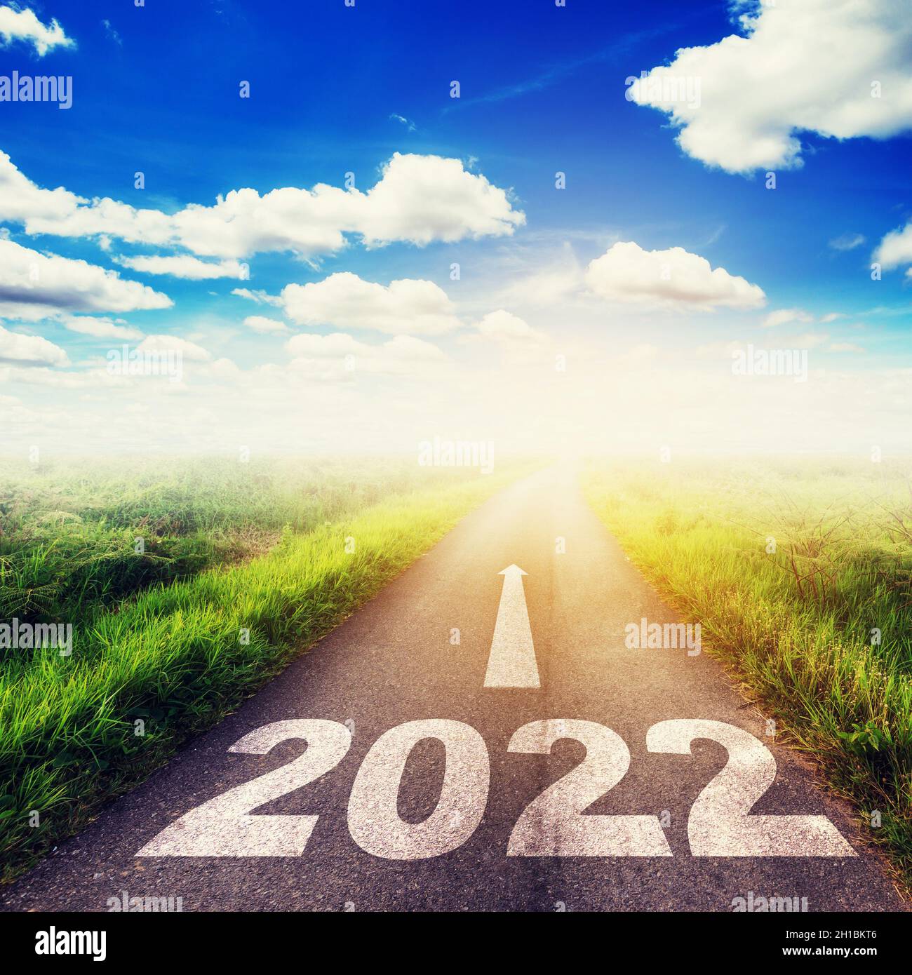 New Year 2022 Goals Concept Empty asphalt road sun and blue sky with
