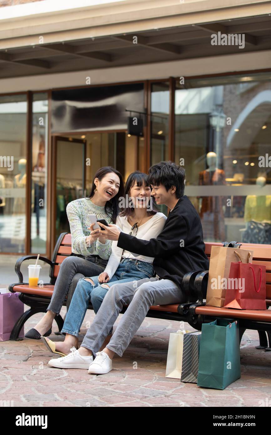 Happy young friends using smart phone Stock Photo