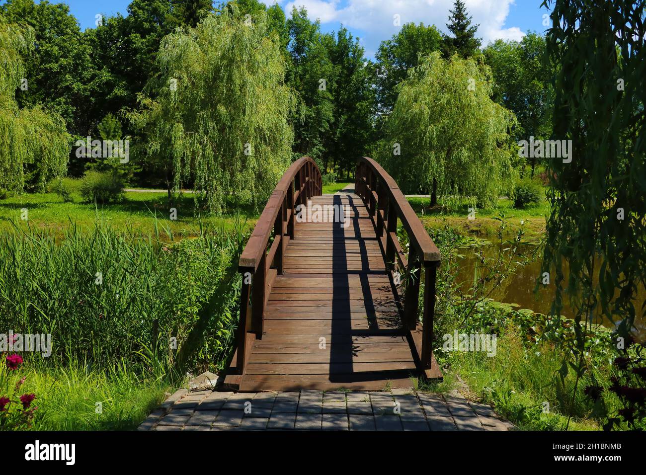 A beautiful wooden walkway across the lake. Stock Photo