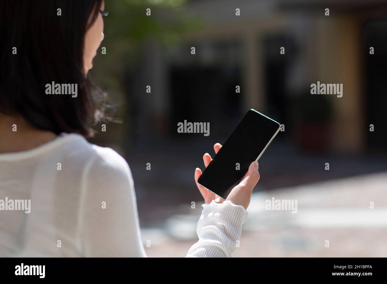 Woman and phone and close up rear view hi-res stock photography and ...