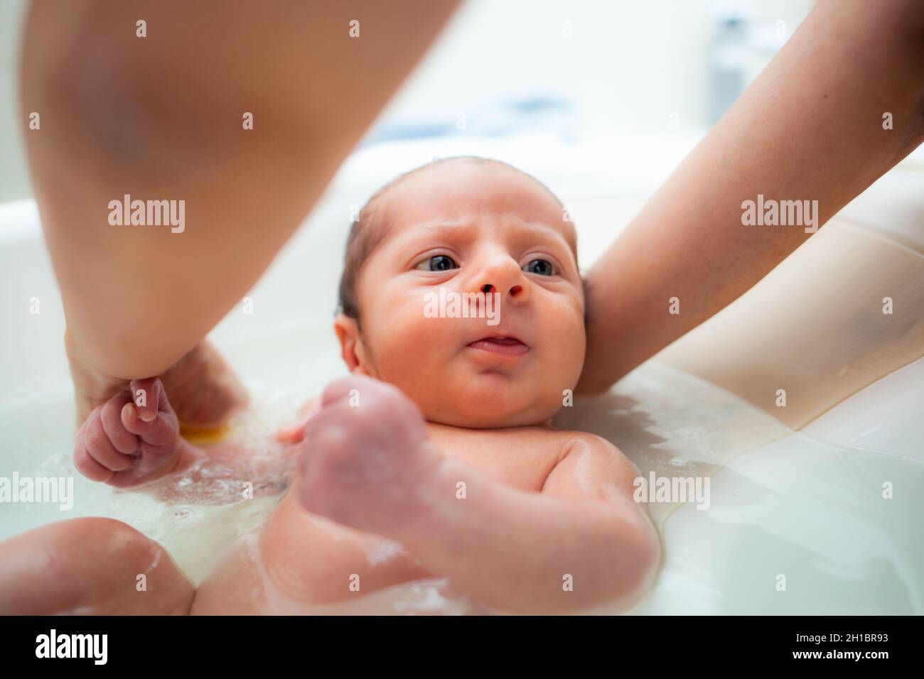 First bath of newborn baby boy. The first bath for a newborn is always a special moment. Stock Photo
