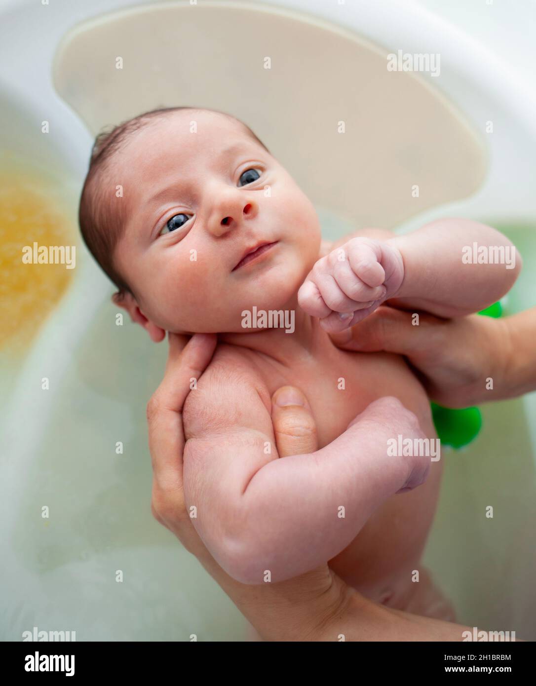 First bath of newborn baby boy. The first bath for a newborn is always a special moment. Stock Photo