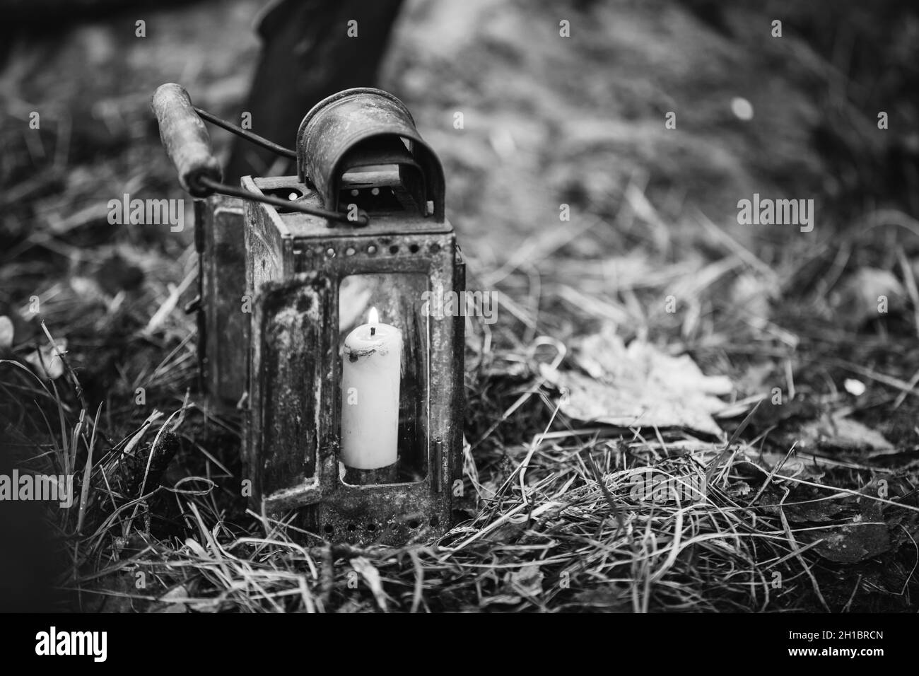 Old Vintage Lantern With Burning Candle On Forest Ground Stock Photo