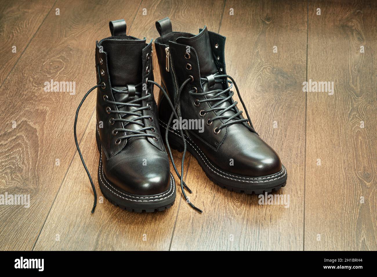 Men's shoes. Black boots on a wooden background. Close up Stock Photo