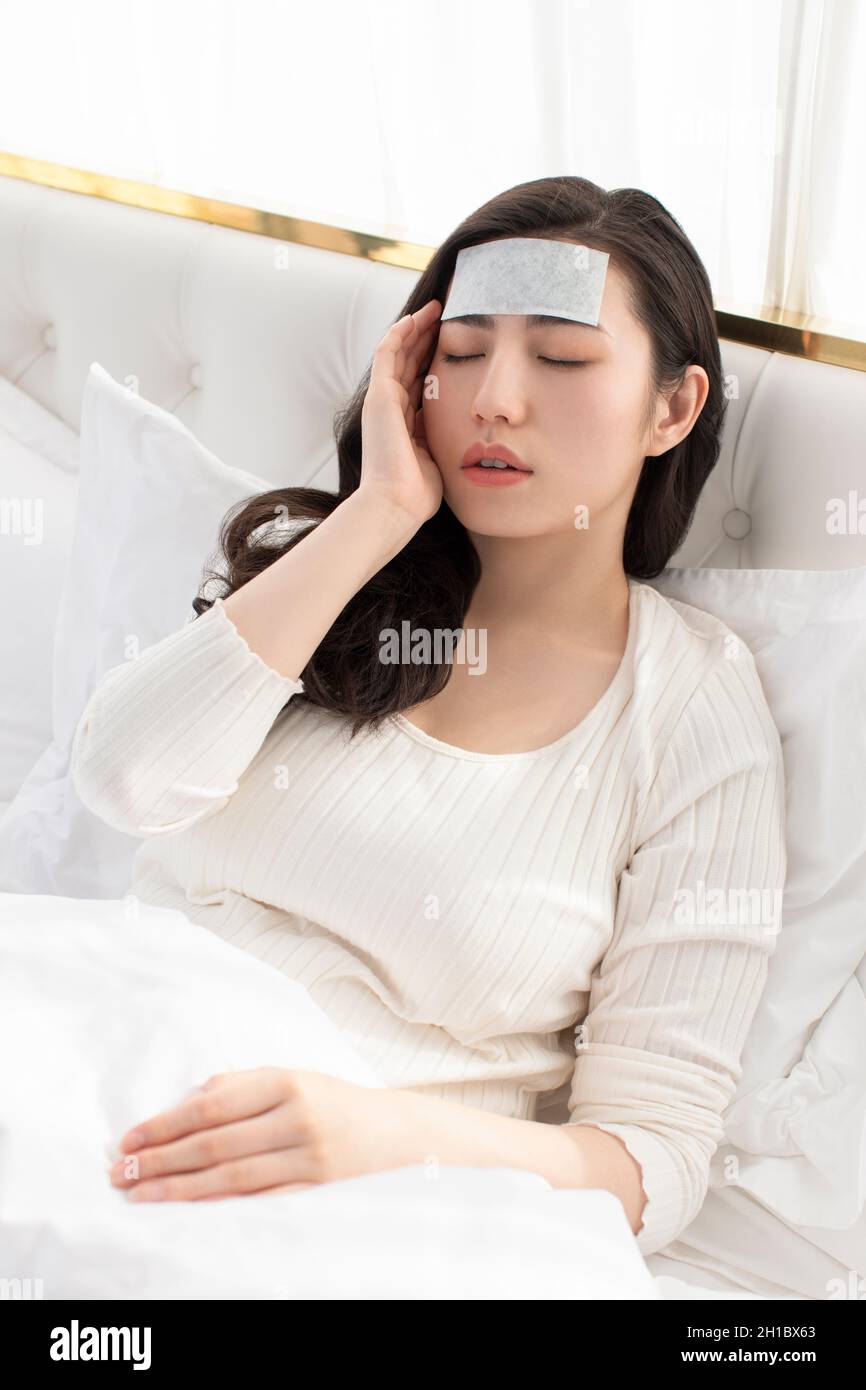 Young woman lying on bed Stock Photo Alamy