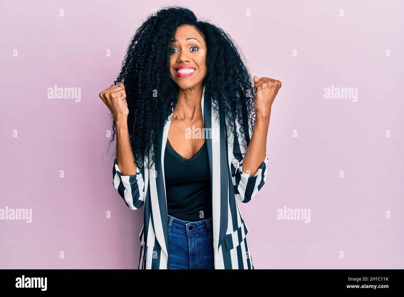 Middle age african american woman wearing casual clothes celebrating ...