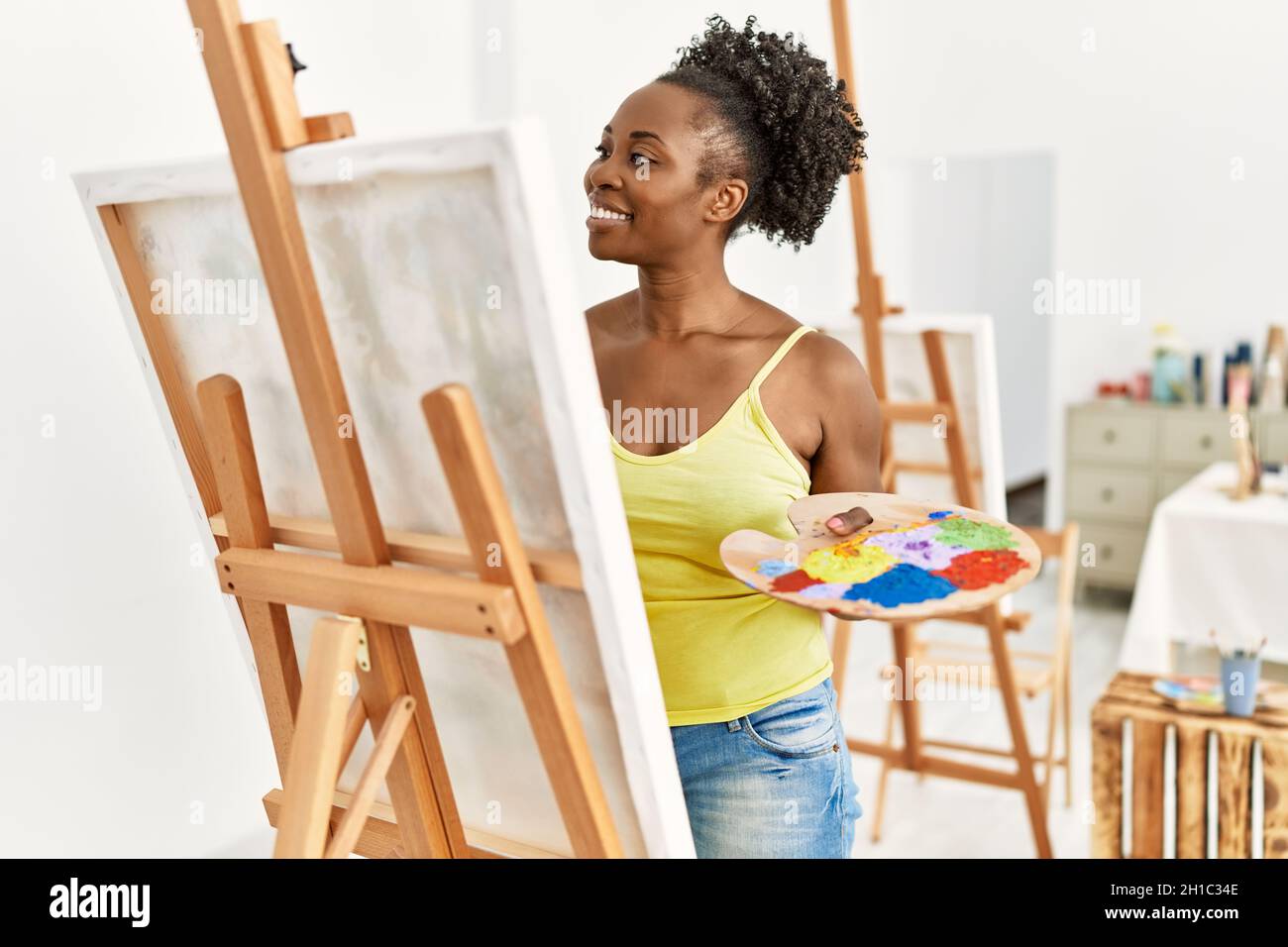 Young african american artist woman smiling happy drawing at art studio ...