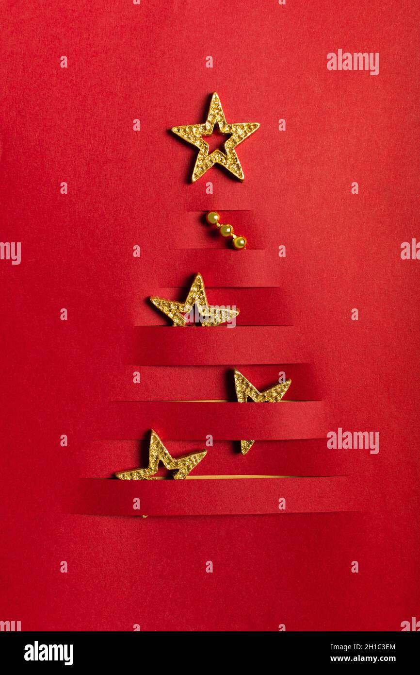 Handmade paper craft Christmas tree with golden stars slot Stock Photo ...
