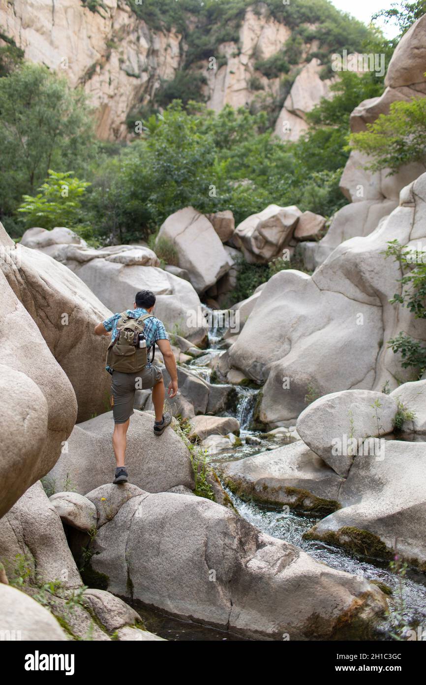 Young man hiking outdoors Stock Photo - Alamy